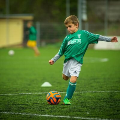 little boy playing football